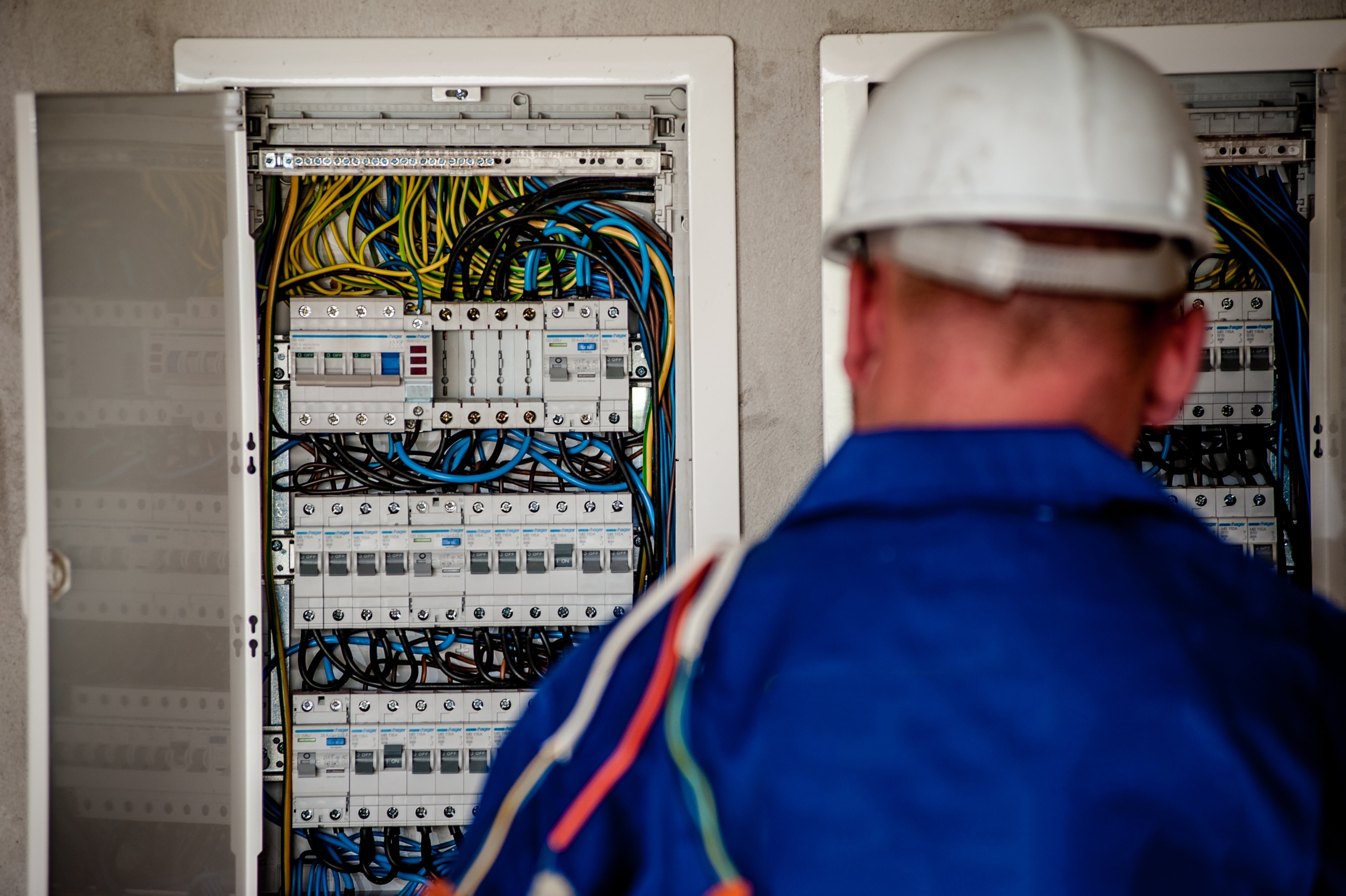 Technician examining electrical panel